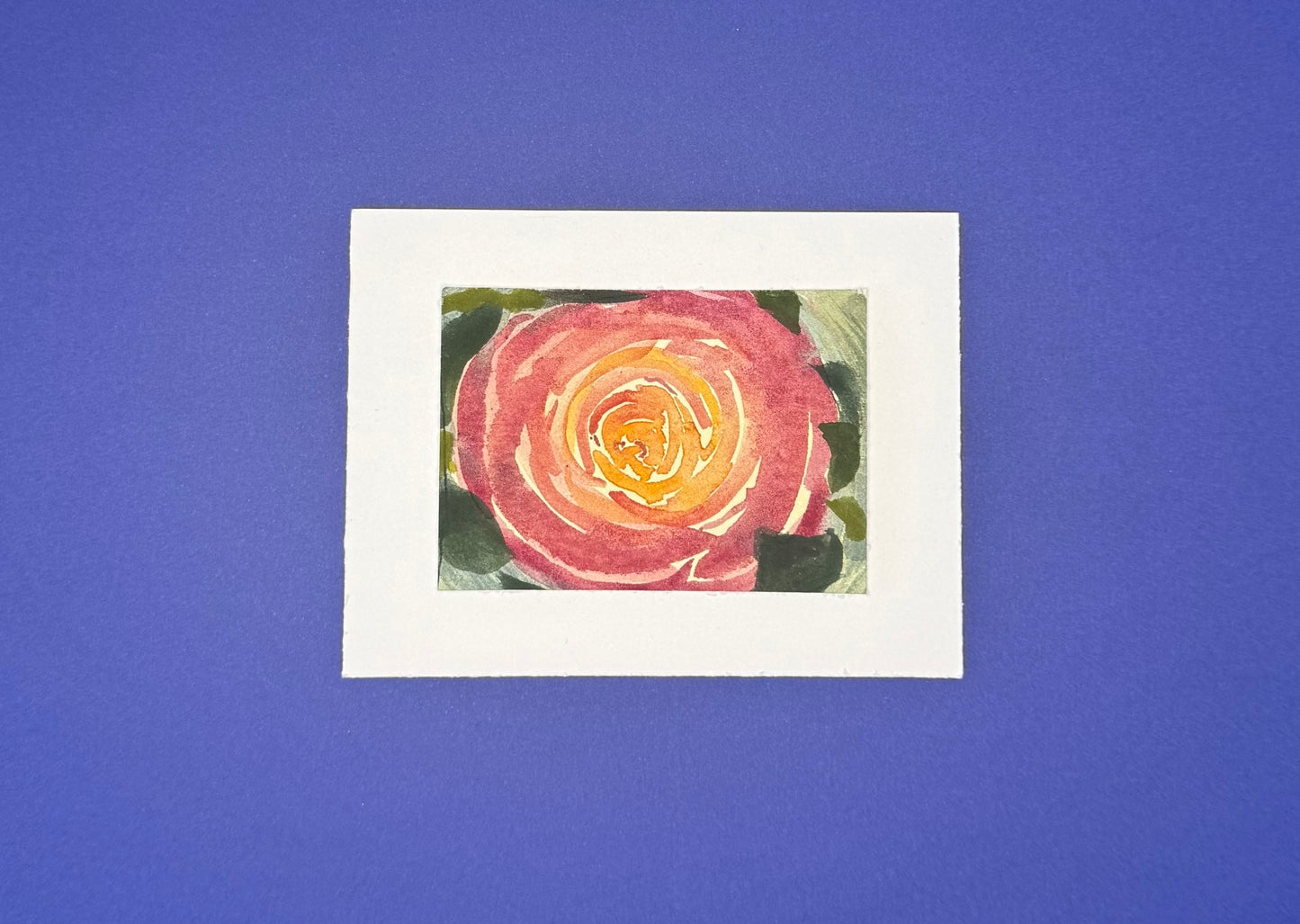 Artistic depiction of a warm, pink flower with a yellow center mounted on premium paper. 