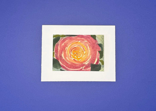 Artistic depiction of a warm, pink flower with a yellow center mounted on premium paper. 