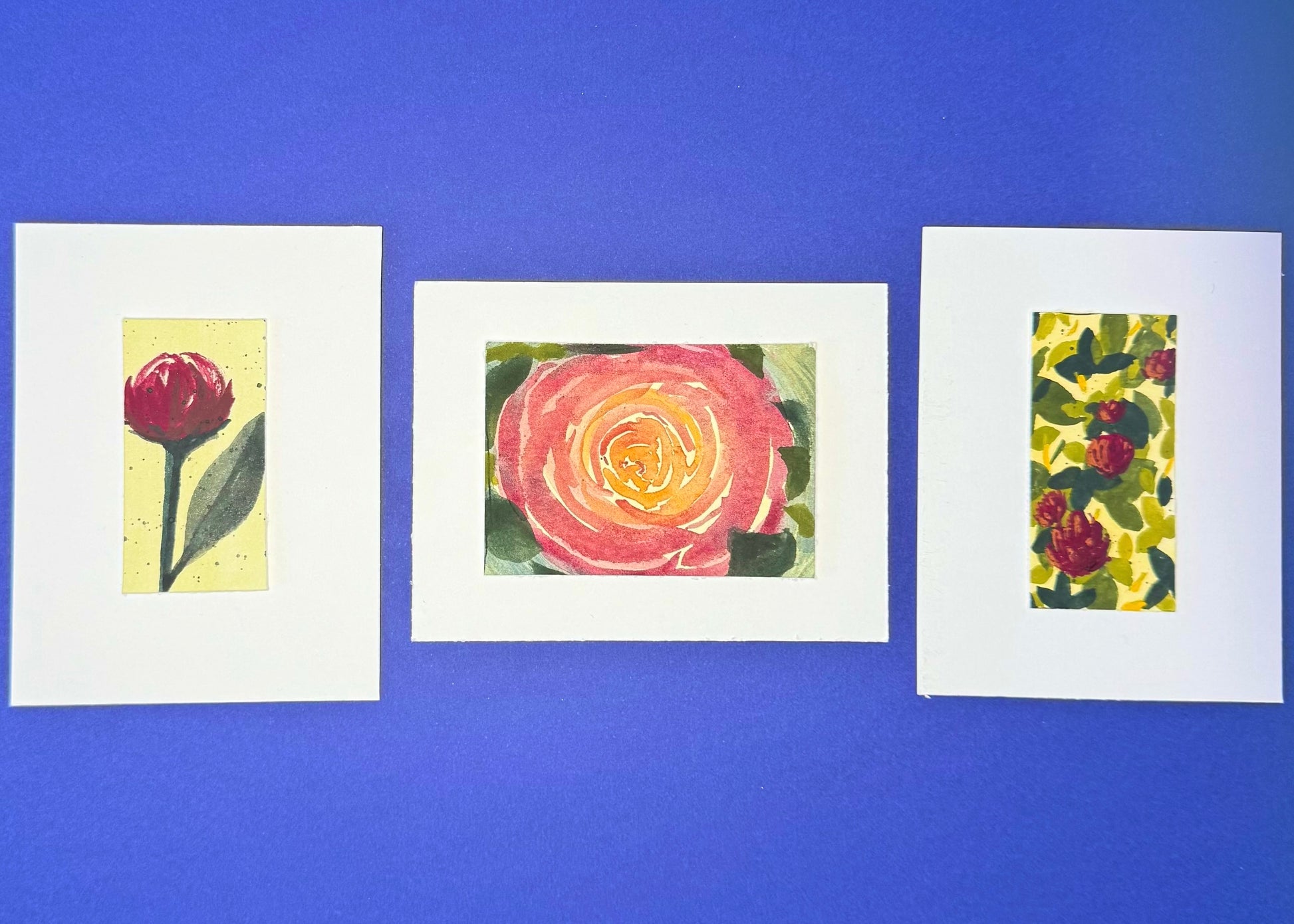 Three framed artworks of luscious florals mounted on premium paper.  
