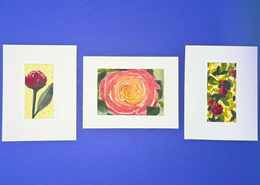 Three framed artworks of luscious florals mounted on premium paper.  